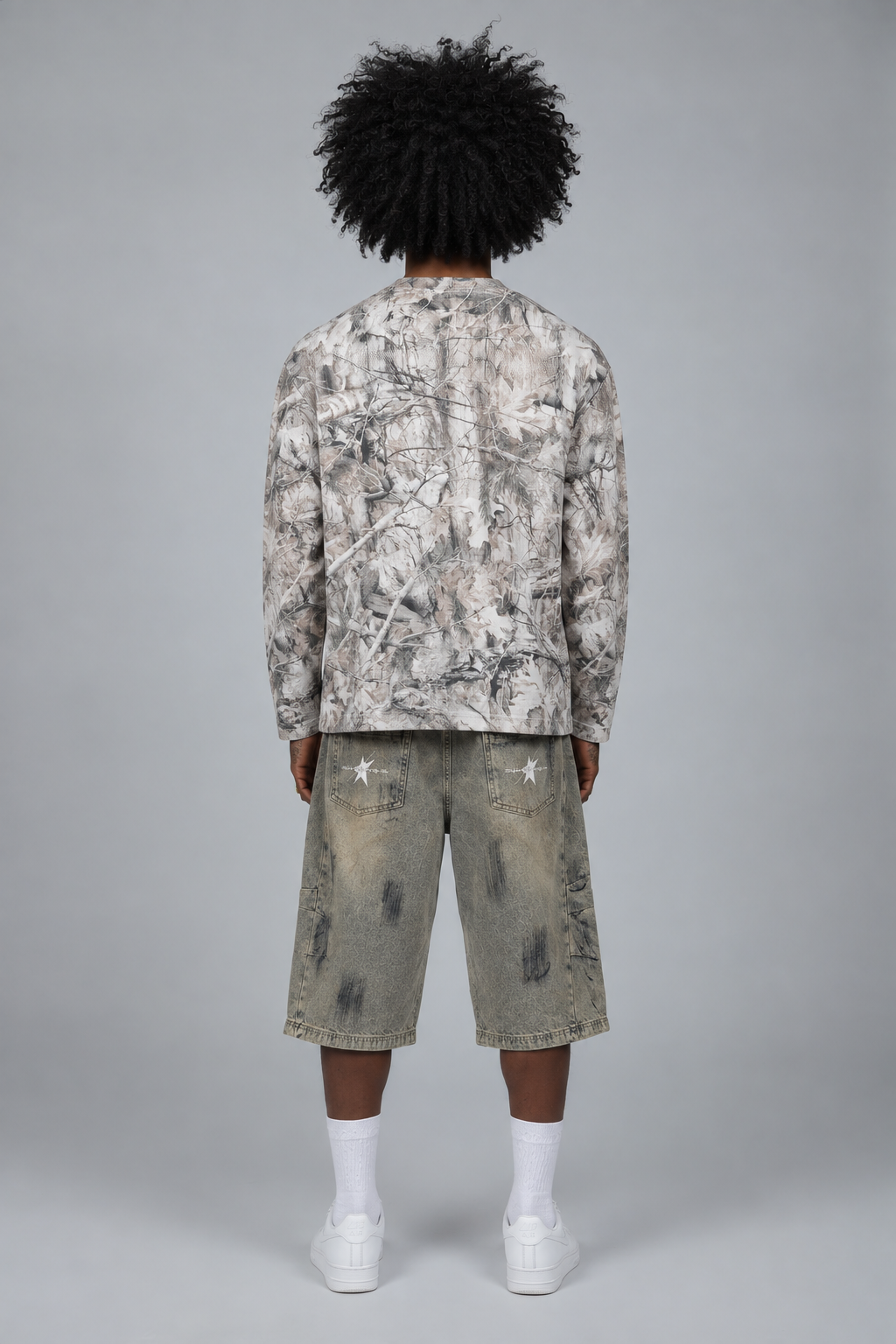 Back view of the camo sweatshirt on the model