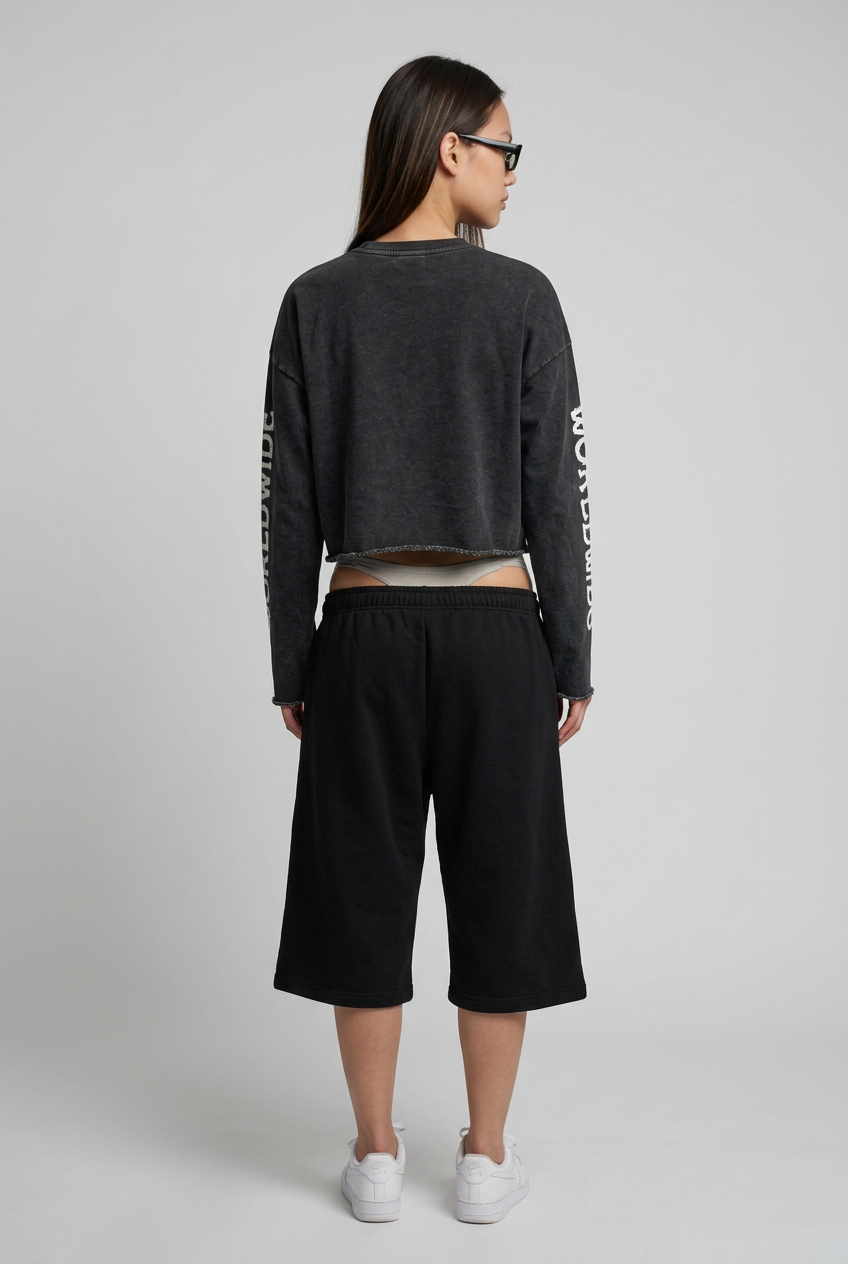 Full-body back view in cropped sweater and shorts