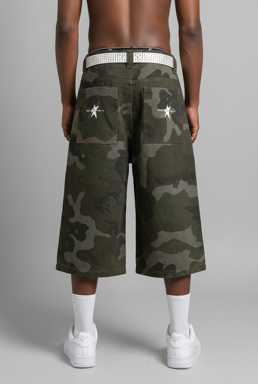 Male model wearing camo shorts with white rhinestone belt, white socks and shoes, back view