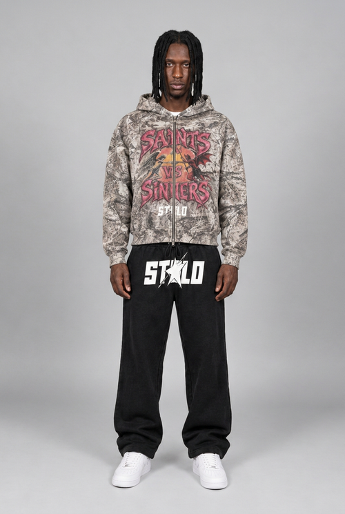 Natural phone-style front view of camo hoodie and black sweats