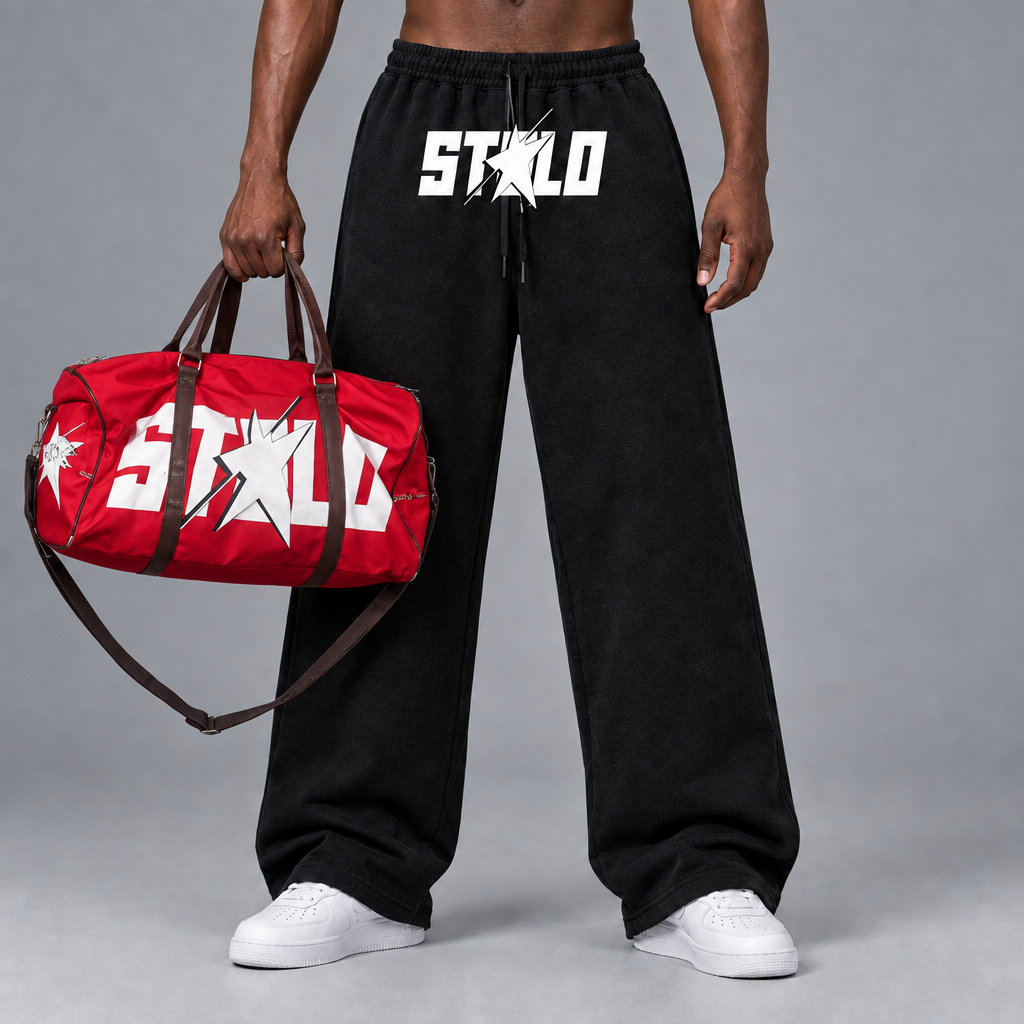 STOLO pants product shot with the red duffle bag held by the model