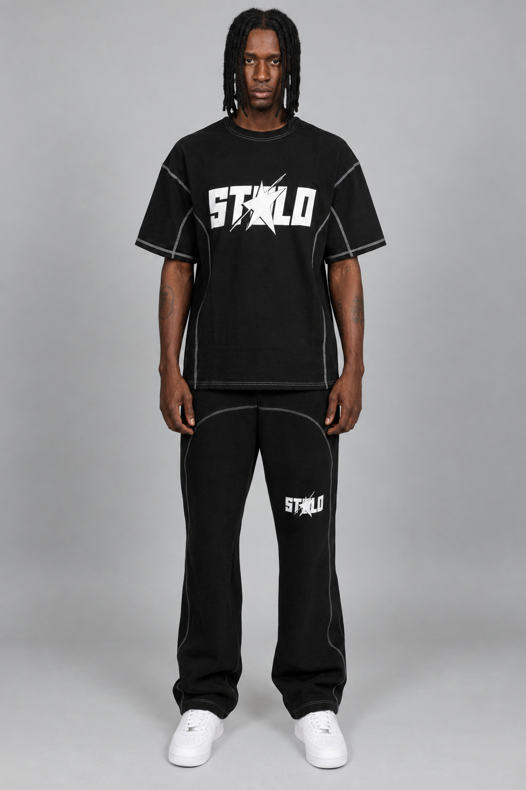 Your model in the black contrast-stitch STOLO set