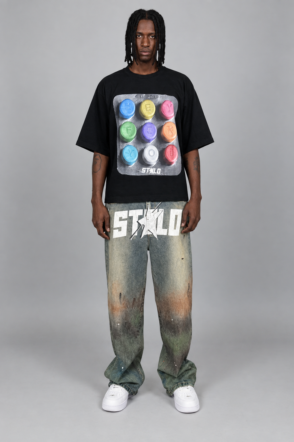 Your model in the black graphic tee and washed jeans