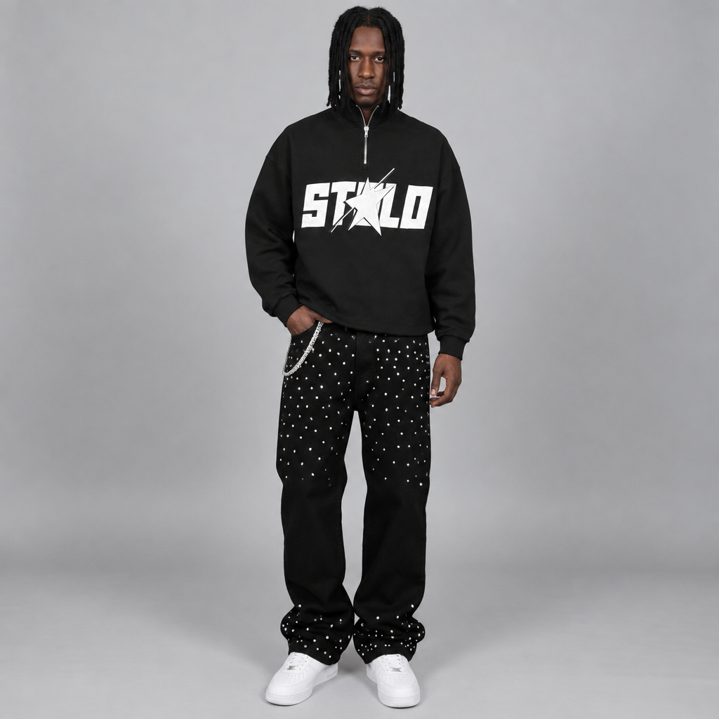 Your model in the black quarter-zip and rhinestone pants, front view
