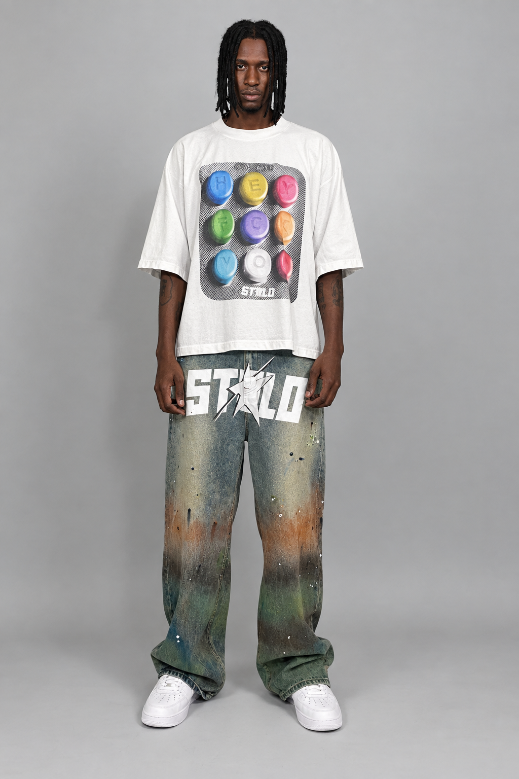 Your model in the white graphic tee and washed jeans
